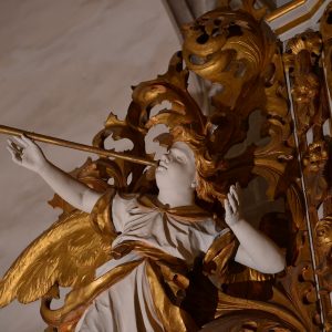 An angel playing the trumpet as a detail of the organ prospectus